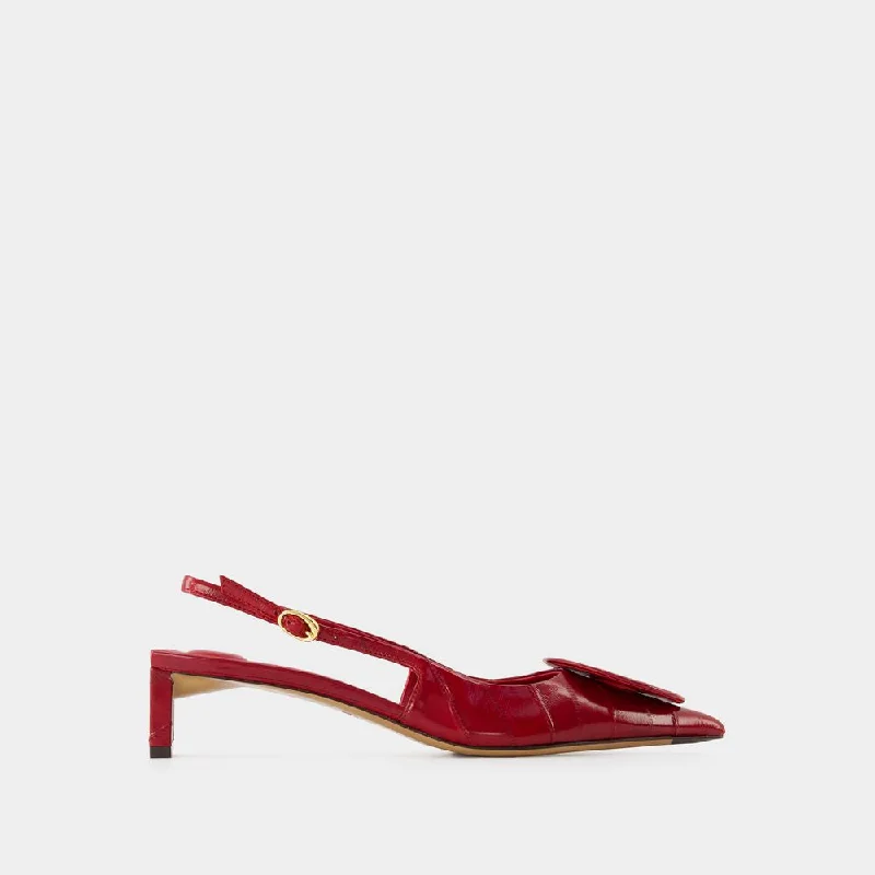 High heels with subtle logos -JACQUEMUS Duelo B Mini Slingback Pumps